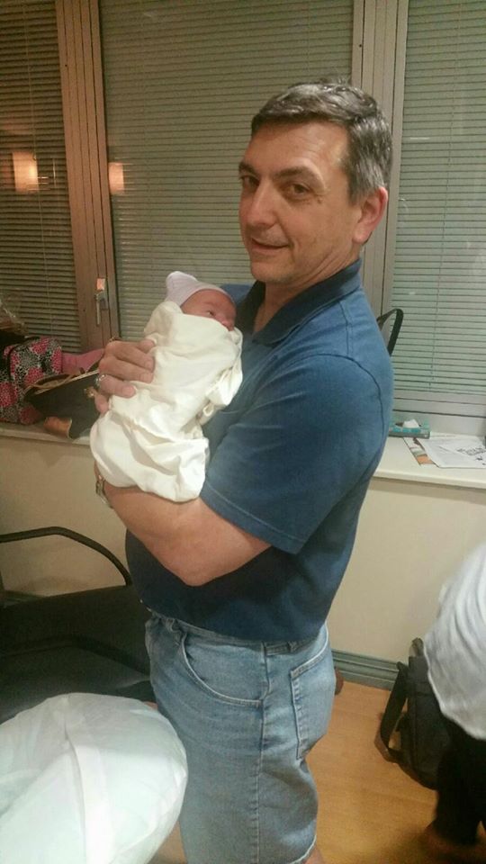 Picture of me holding my wife's youngest grandchild on the day she was born